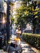 A woman in a yellow dress is walking down the street.