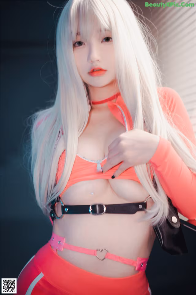 A woman with long white hair wearing a pink outfit.
