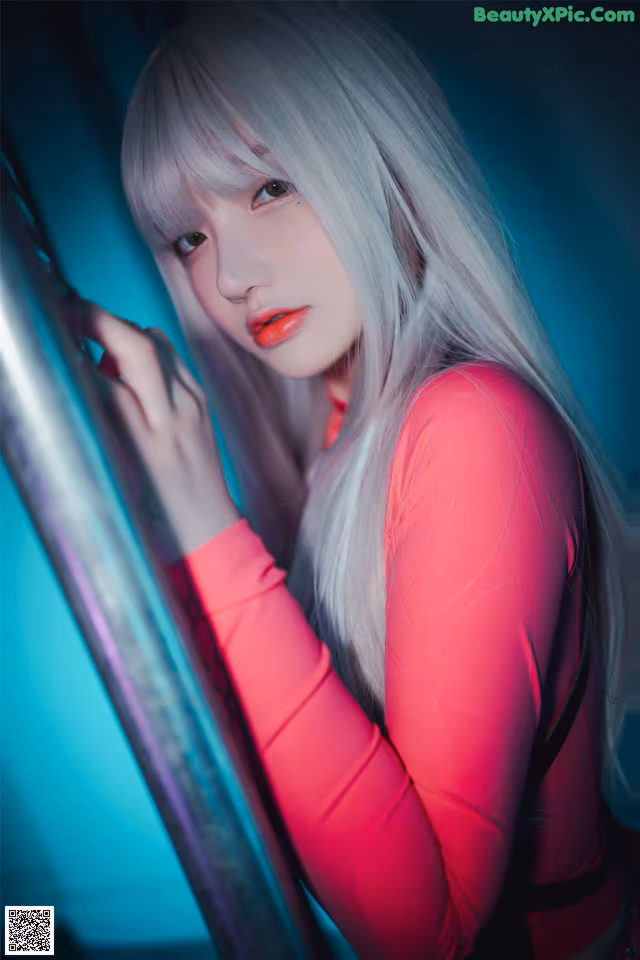 A woman with long white hair leaning against a pole.