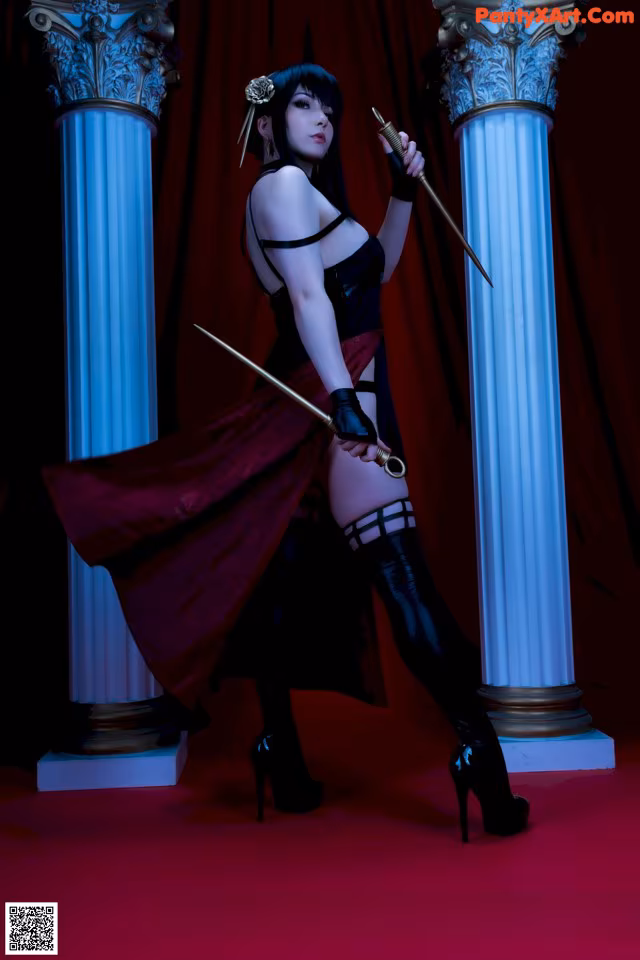 A woman in a black dress holding a sword.