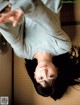 A woman laying on the floor with her arms outstretched.