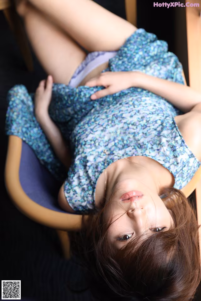 A woman laying on a chair with her legs crossed.