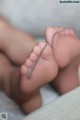 A close up of a baby's feet with a string attached to them.