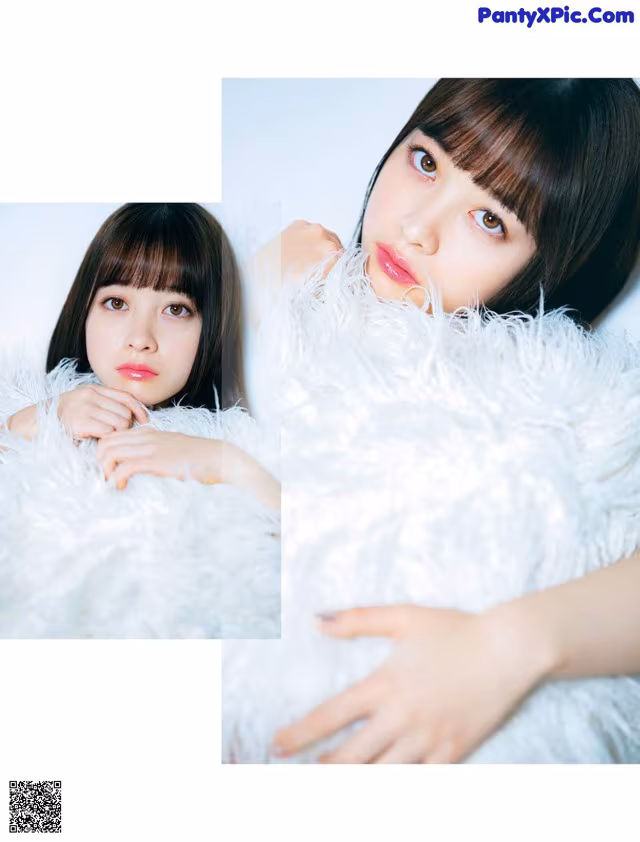 A woman laying on top of a fluffy white blanket.