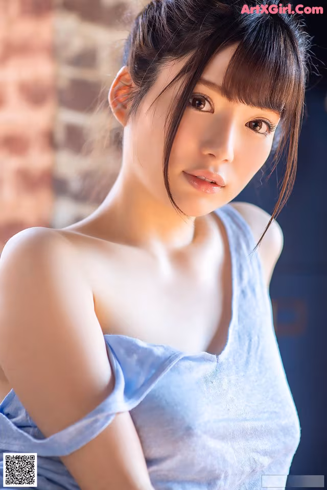 A woman in a blue dress posing for a picture.