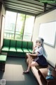 A girl sitting on a bench in a room.